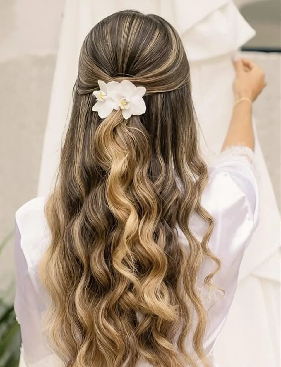 Penteado semipreso com ondas e acessório floral
